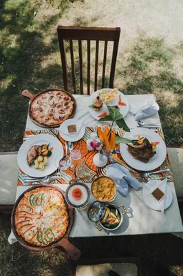 a table with plates of food on top at Airport Planet Lodge in Kingori