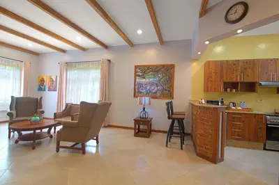 a living room with a kitchen and a dining room at Airport Planet Lodge in Kingori