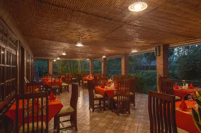 a restaurant with tables and chairs with red table cloth at Airport Planet Lodge in Kingori
