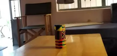 a multicolored cup sitting on top of a table at Maasai Hostel Tanzania in Arusha