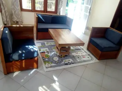 a living room with two chairs and a coffee table at Le Parlour in Boma la Ngombe