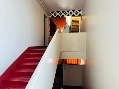 a staircase with red stairs in a building at Arusha Backpackers Hotel in Arusha