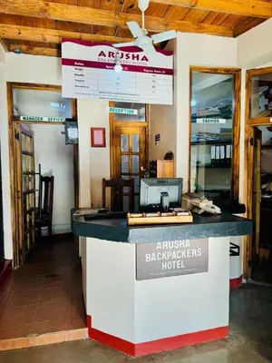 a bar in a building with a sign on it at Arusha Backpackers Hotel in Arusha