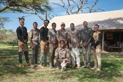 a group of men posing for a picture with a sheep at Gnu Ndutu Camp in Sinoni