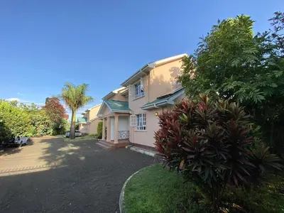 a house with a driveway in front of it at Daria Apartment -Burka -3 minutes from Arusha Airport in Arusha