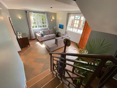 a view of a living room with a staircase at Daria Apartment -Burka -3 minutes from Arusha Airport in Arusha
