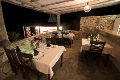 a restaurant with white tables and chairs with flowers on them at Arusha Villa Karamu Coffee Estate in Usa River