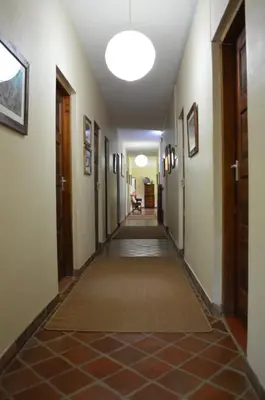 an empty hallway in a building with a light fixture at The Researchers Rest in Arusha