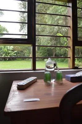 a table with a tea pot and a remote control at The Researchers Rest in Arusha