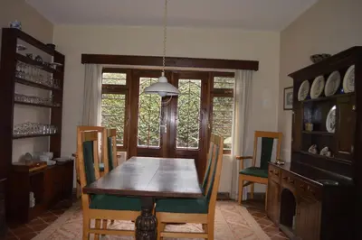 a dining room with a wooden table and chairs at The Researchers Rest in Arusha