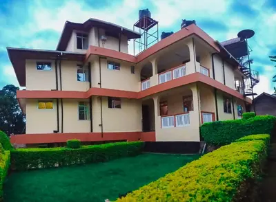 a large house with a green yard in front of it at Shimbwe Meadows Home in Moshi