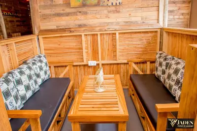 a room with two benches and a table in a sauna at Jaden Hotel & Lounge - Arusha in Arusha