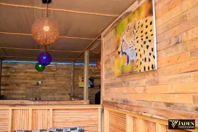 a room with a wooden wall with a painting of a leopard at Jaden Hotel & Lounge - Arusha in Arusha