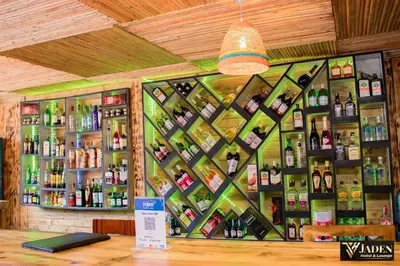 a bar with a wall of bottles of alcohol at Jaden Hotel & Lounge - Arusha in Arusha