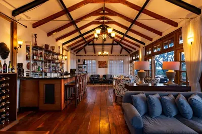 a living room with a bar and a couch at Ngorongoro Lion's Paw in Ngorongoro