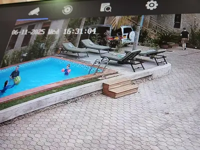 a swimming pool with two people playing in it at Mrimba Palm Hotel in Arusha