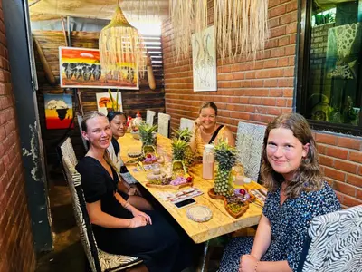 a group of women sitting at a table in a restaurant at Savannah House in Arusha