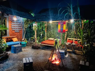 a patio with a bed and a fire in a room at Savannah House in Arusha