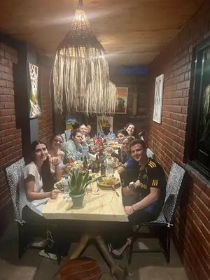 a group of people sitting around a table in a restaurant at Savannah House in Arusha