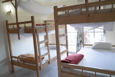 a bedroom with two bunk beds in a room at Wakawaka Hostel Arusha in Arusha