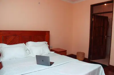 a laptop computer sitting on top of a bed at Wakawaka Hostel Arusha in Arusha