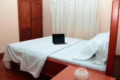 a laptop computer sitting on top of a bed at Wakawaka Hostel Arusha in Arusha