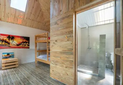 a bathroom with a shower and a crib in a room at Banana Farm Eco Hostel in Arusha