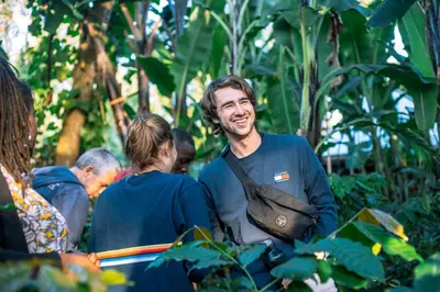 a man standing in a group of people at Banana Farm Eco Hostel in Arusha