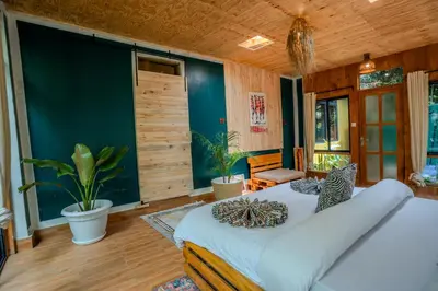 a bedroom with a large white bed in a room at Banana Farm Eco Hostel in Arusha
