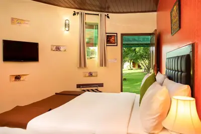 a bedroom with a white bed and a window at Fun Retreat Resort, Hotel and Ayurveda Spa in Arusha