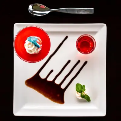a white plate with a fork and dessert on it at Fun Retreat Resort, Hotel and Ayurveda Spa in Arusha