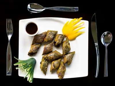 a plate of food with tofu and a flower on it at Fun Retreat Resort, Hotel and Ayurveda Spa in Arusha