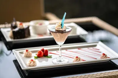 a dessert in a martini glass on a tray with strawberries at Fun Retreat Resort, Hotel and Ayurveda Spa in Arusha