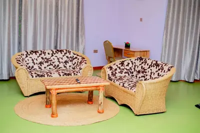 a living room with two chairs and a coffee table at Asmorein Hotel in Babati