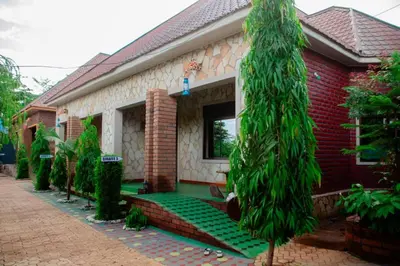 a house with a green lawn in front of it at Asmorein Hotel in Babati