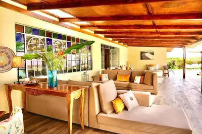 a living room with couches and a table at Pink Flamingo Boutique Hotel in Moshi