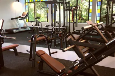 a gym with a bunch of tread machines in it at Pink Flamingo Boutique Hotel in Moshi