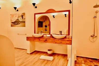 a bathroom with two sinks and a large mirror at Pink Flamingo Boutique Hotel in Moshi
