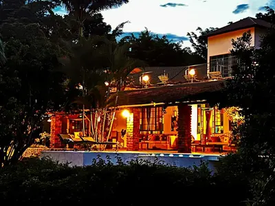 a house with a swimming pool at night at Pink Flamingo Boutique Hotel in Moshi