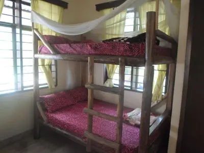 a couple of bunk beds in a room at Climbers Home in Moshi
