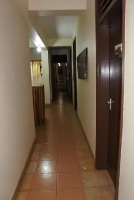 a hallway in a house with a long corridor at Climbers Home in Moshi
