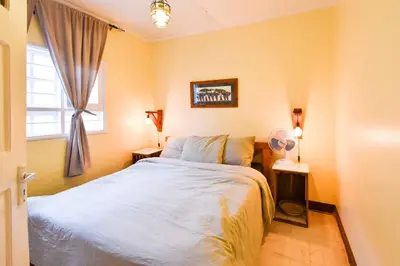a bedroom with a bed and a window at Utamaduni House B&B in Arusha