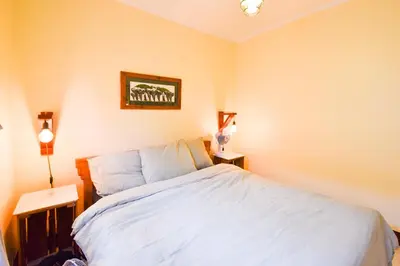 a bedroom with a bed and a picture on the wall at Utamaduni House B&B in Arusha