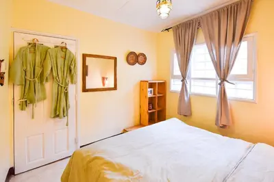 a bedroom with a bed and a window at Utamaduni House B&B in Arusha