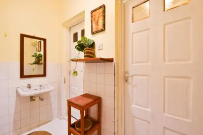 a bathroom with a toilet and a sink at Utamaduni House B&B in Arusha