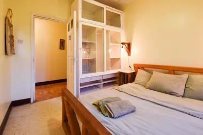 a bedroom with a bed with a glass cabinet at Utamaduni House B&B in Arusha