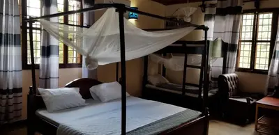 a bedroom with two bunk beds with a mosquito net at Aivlys Lodge Kilimanjaro in Msaranga