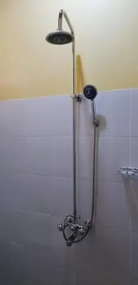 a shower in a bathroom with a shower head at Aivlys Lodge Kilimanjaro in Msaranga
