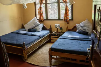 a bedroom with two beds and a window at Kiwavi Home in Moshi
