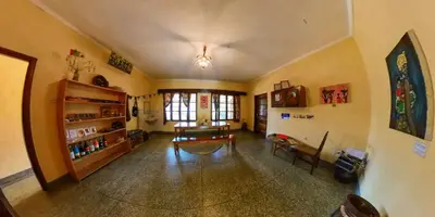 a large living room with a table and a chair at Kiwavi Home in Moshi